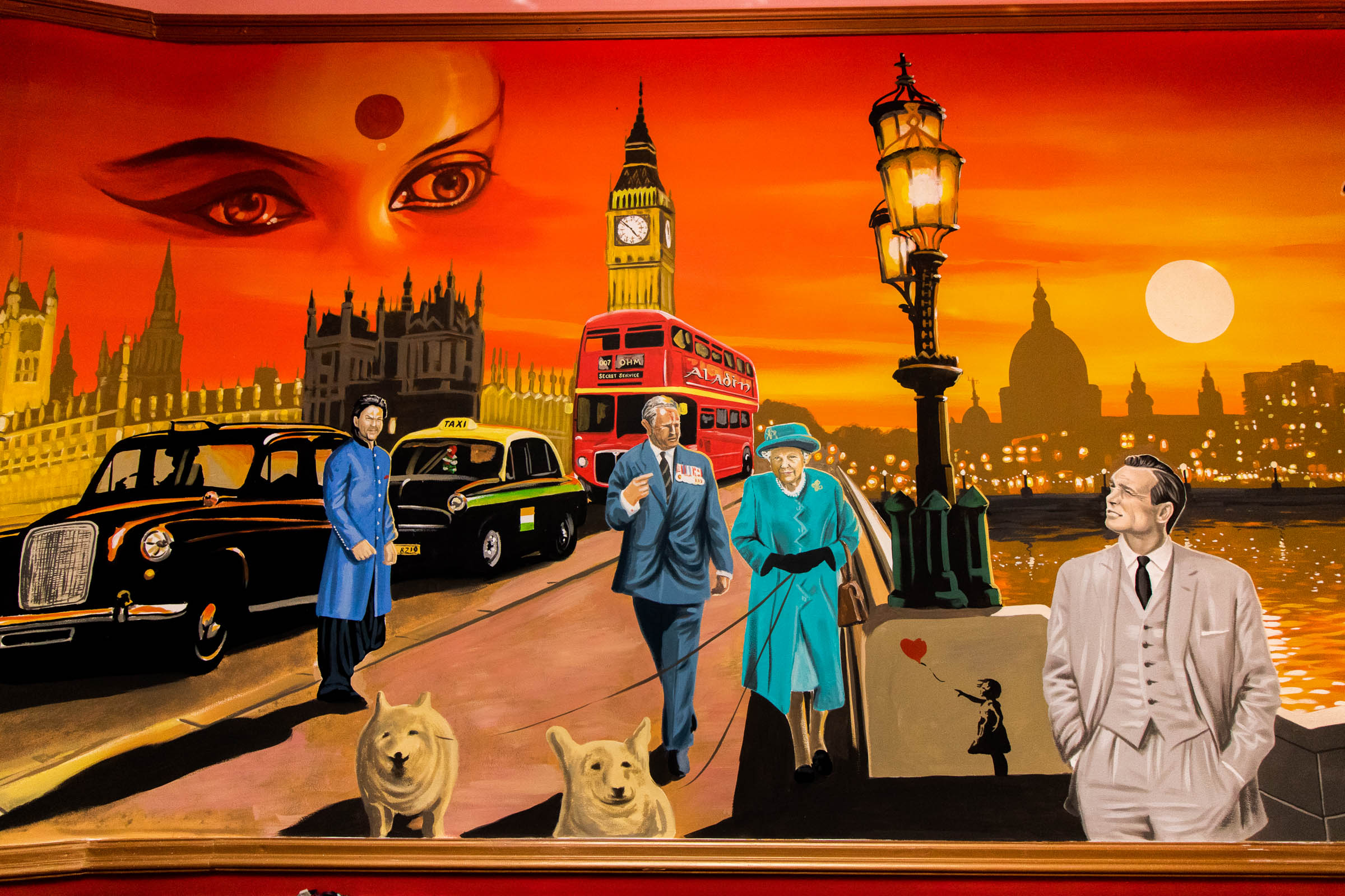 Mural in Aladin restaurant with Shah Rukh Khan, some Indian Goddess eyes, London and Delhi taxis, the Queen and Prince Charles, James Bond and a bit of Banksy