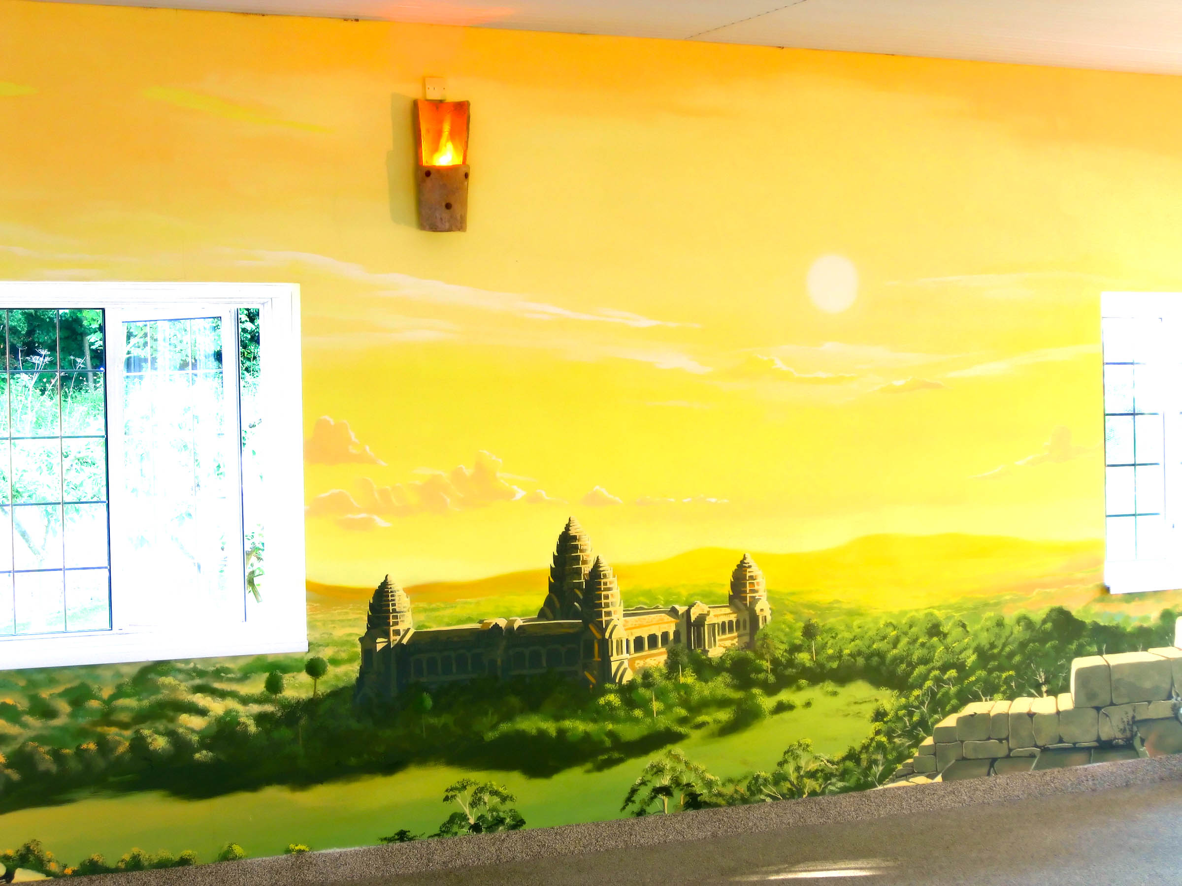 Mural view across the countryside at sunset and the Angkor wat Temple itself