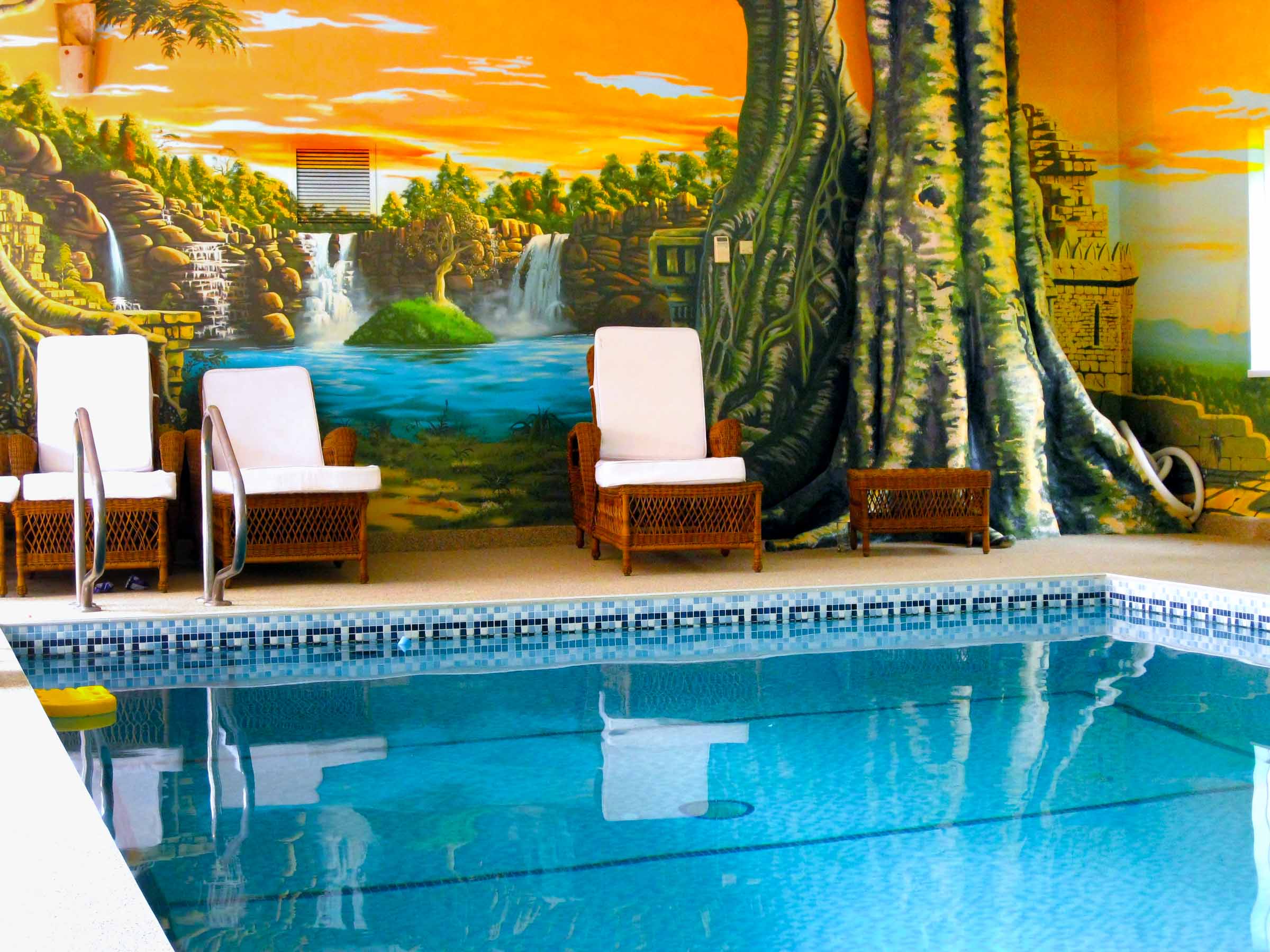 Pool Loungers around oasis mural