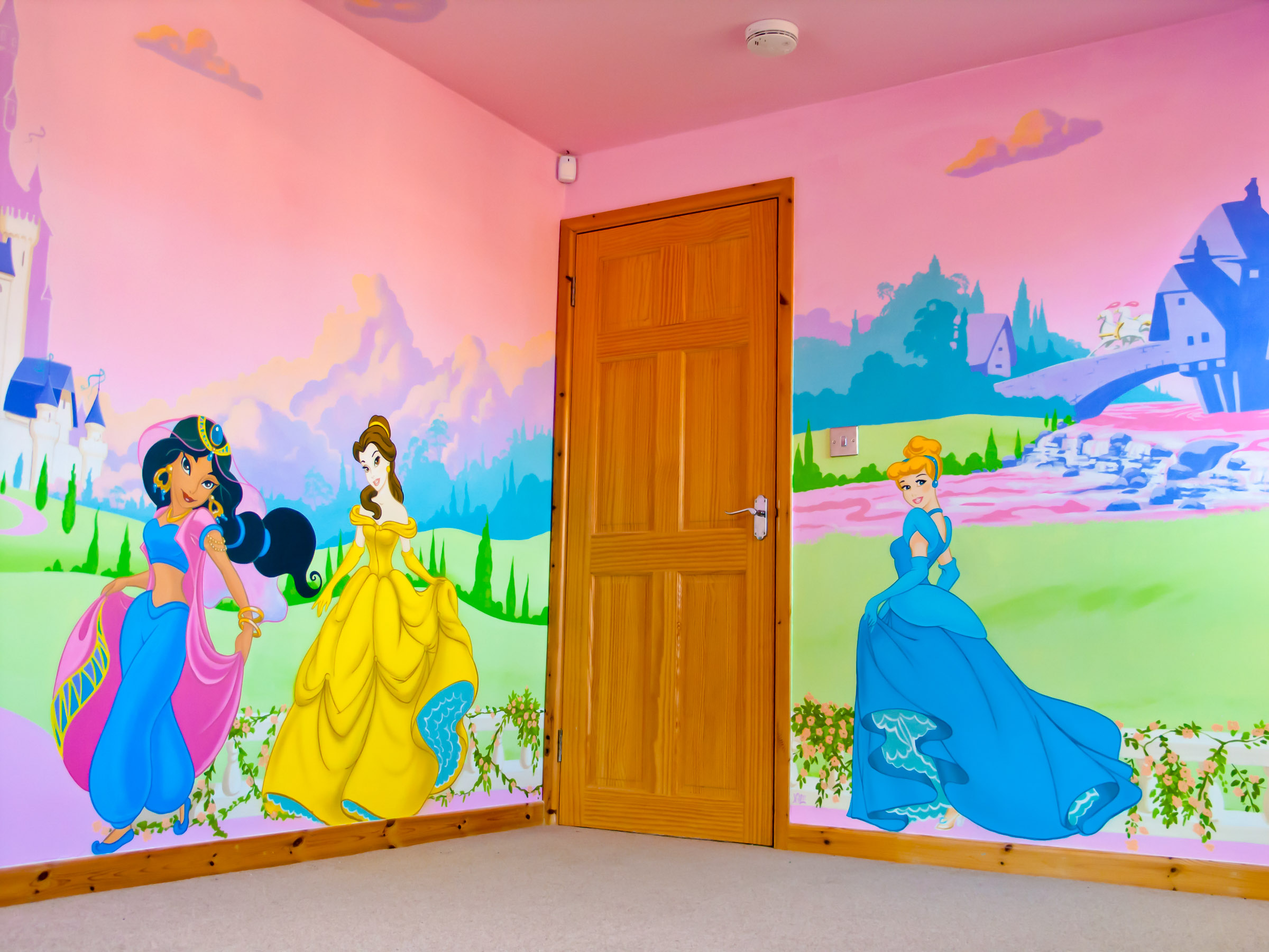 Disney mural with princesses Jasmin, Belle and Cinderella. Shows the entrance door.