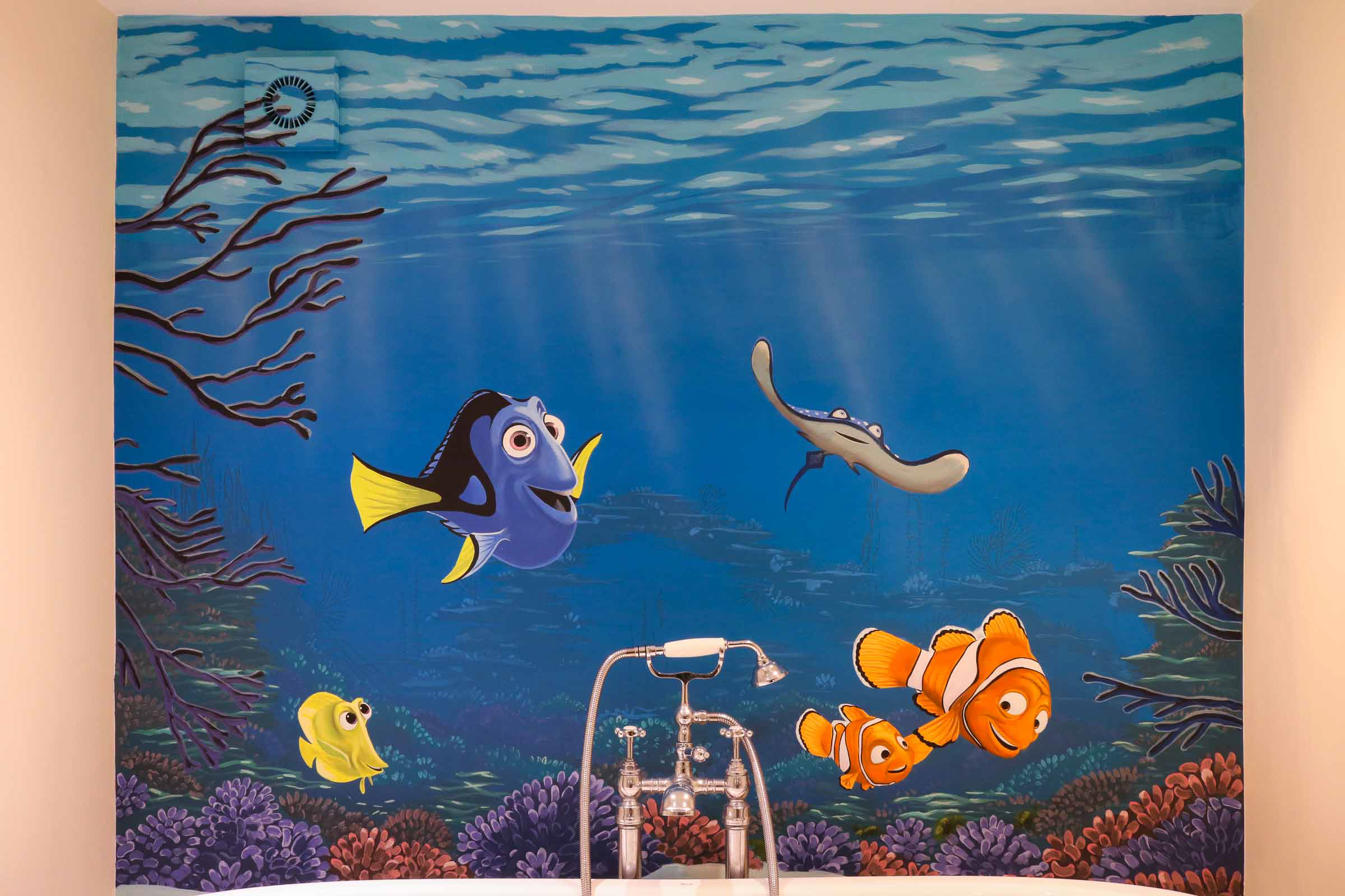 Characters and coral reef from Finding Nemo come to life in this bathroom mural