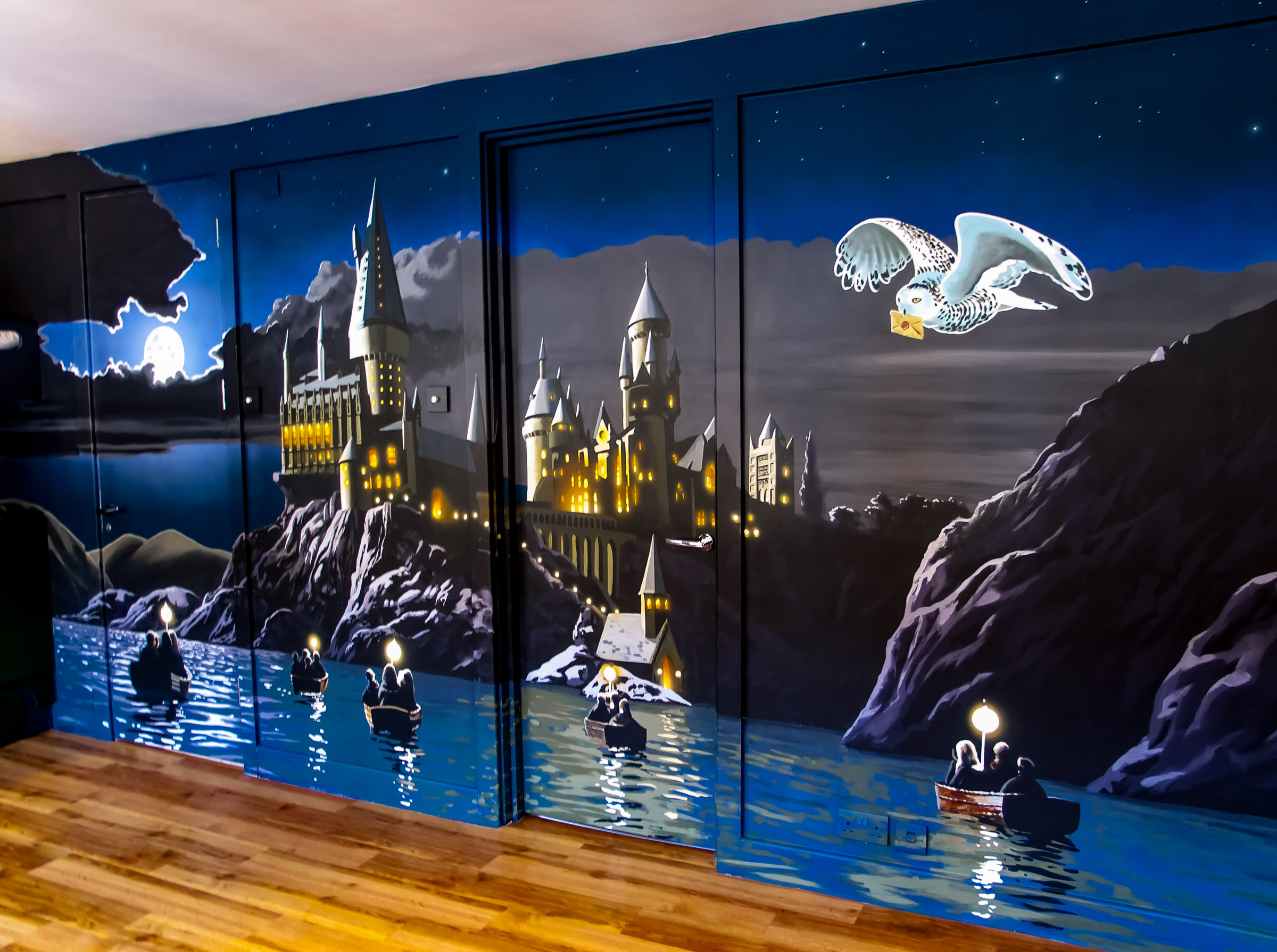 Mural of Hogwarts, Harry Potter, from the lake in moonlight, making the most of the space by concealing the doors and frames