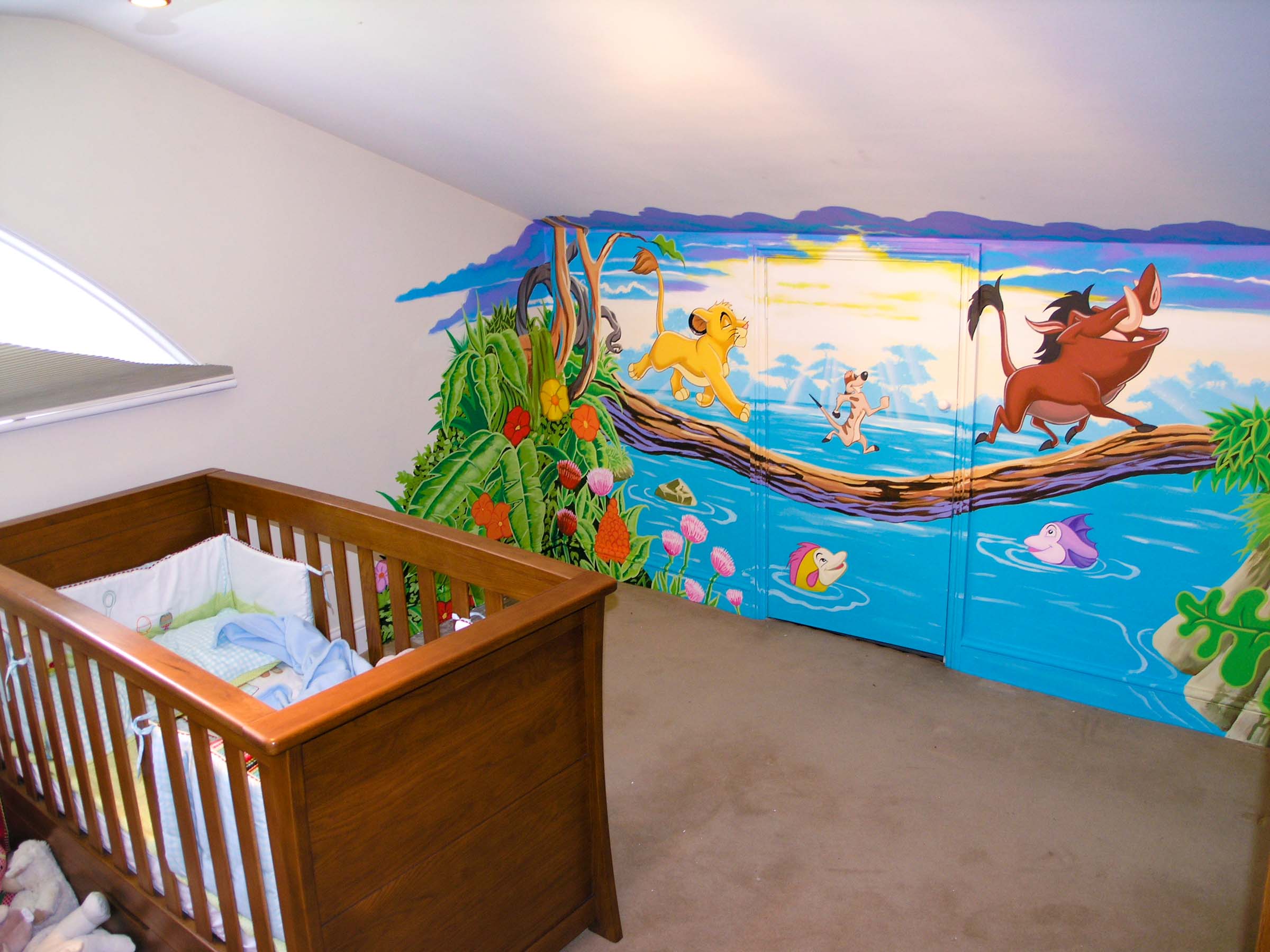 Disney's Lion King wall mural handpainted in attic room nursery, hiding a cupboard door beautifully