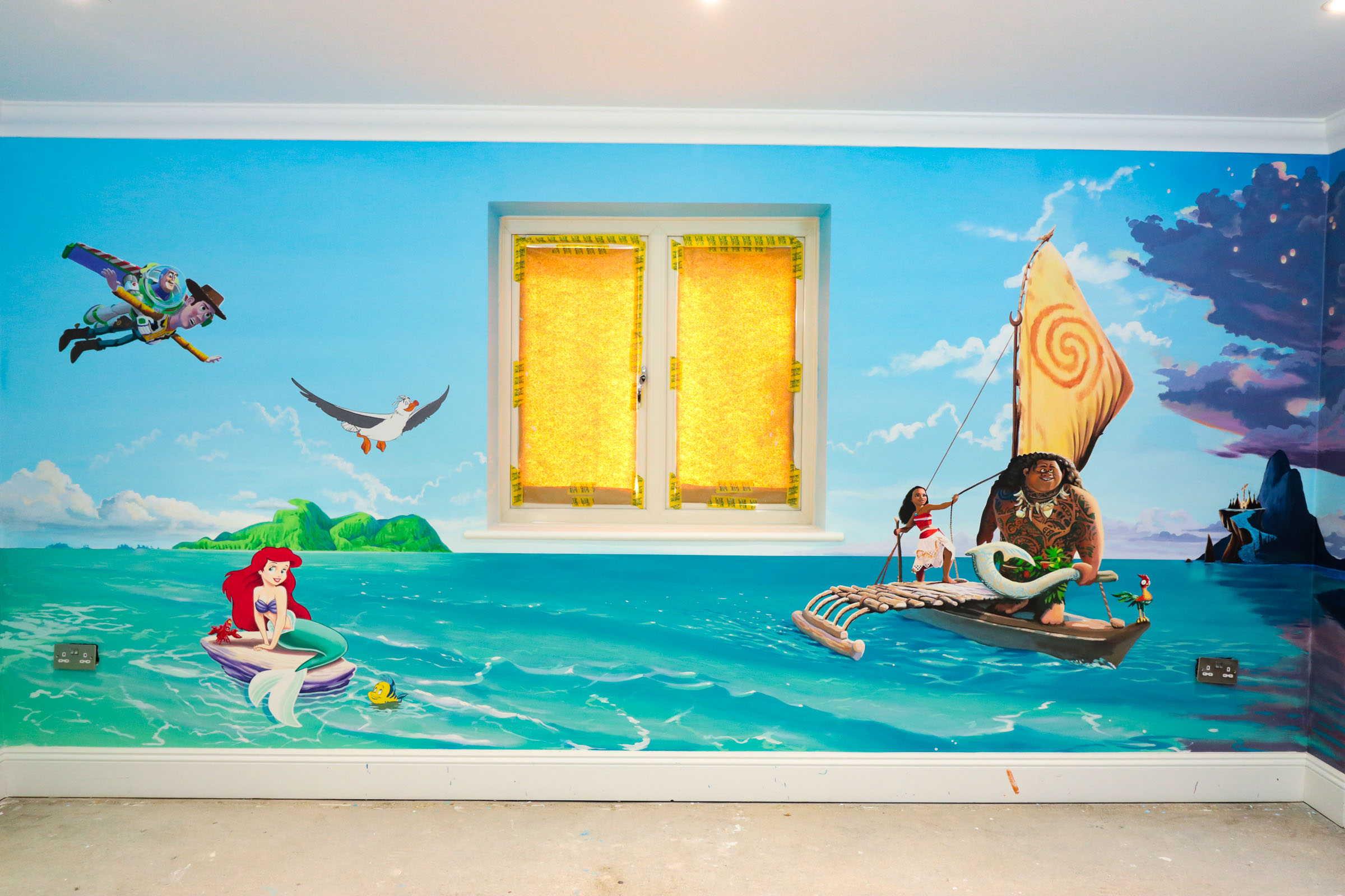 playroom mural, featuring Jungle book characters Mowgli Bagheera and Baloo, plus Lilo and Stitch, the Little Mermaid, Woody and Buzz Lightyear and more details in an expansive Moana backdrop