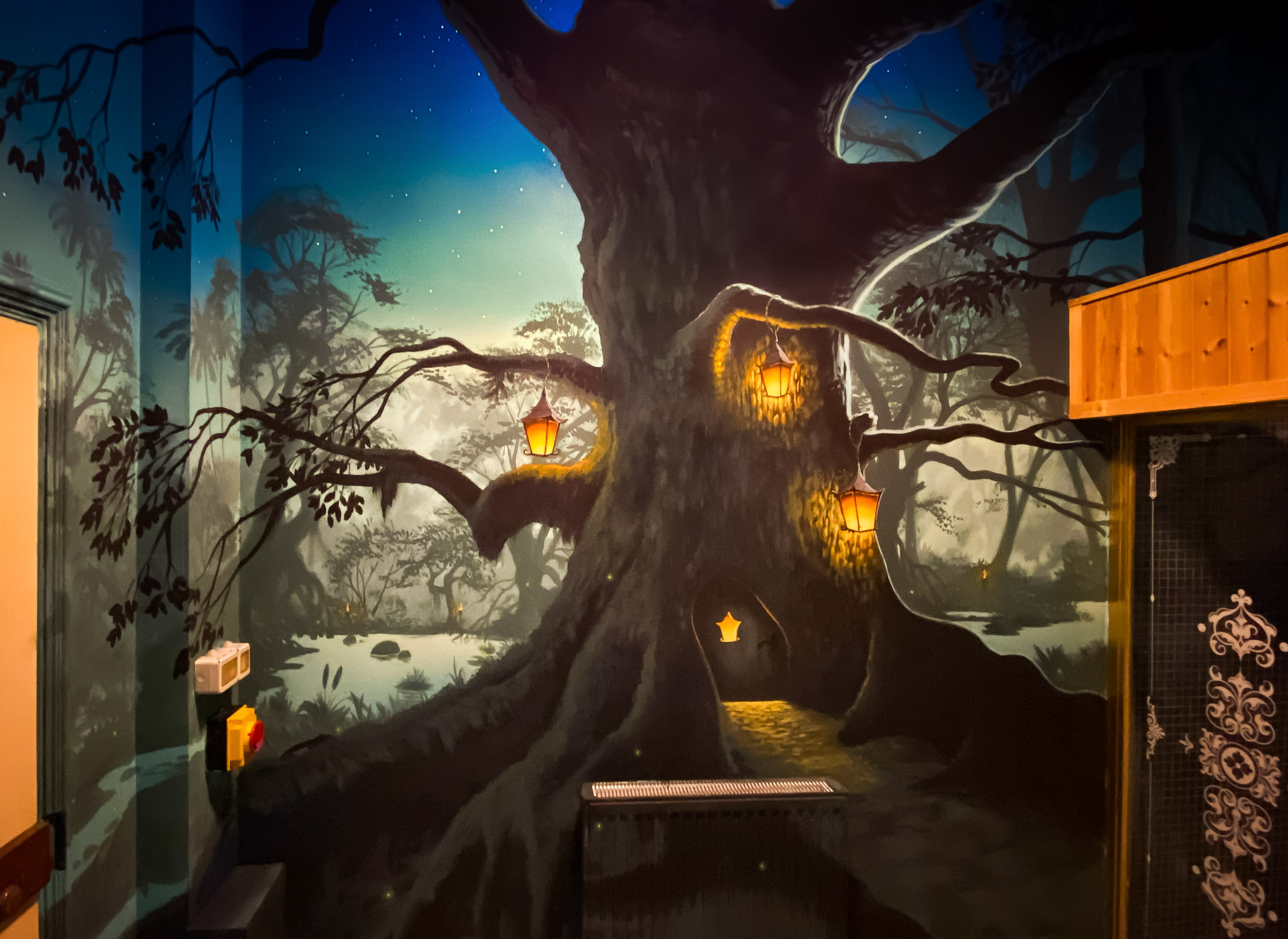 Lantern lit swamp Mural, here featuring a large, lived in tree