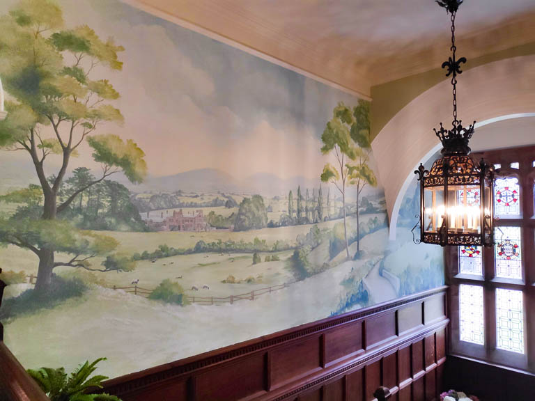 Watercolour style landscape mural in period property