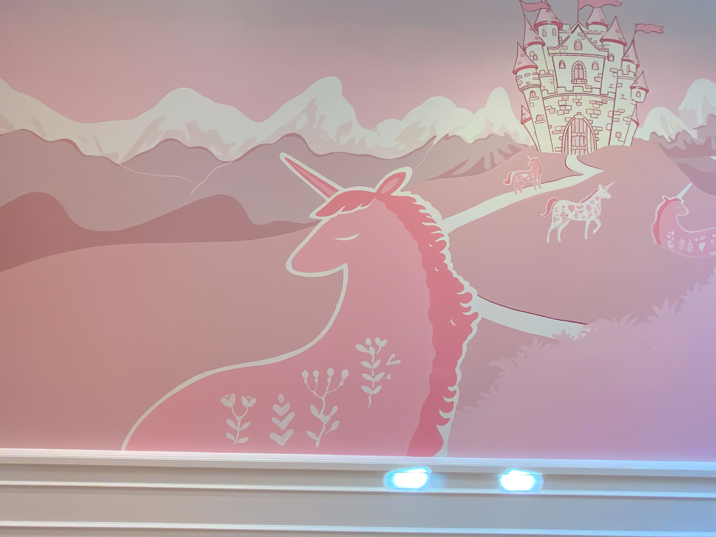 The main stylised unicorn painted in fuller pink tones