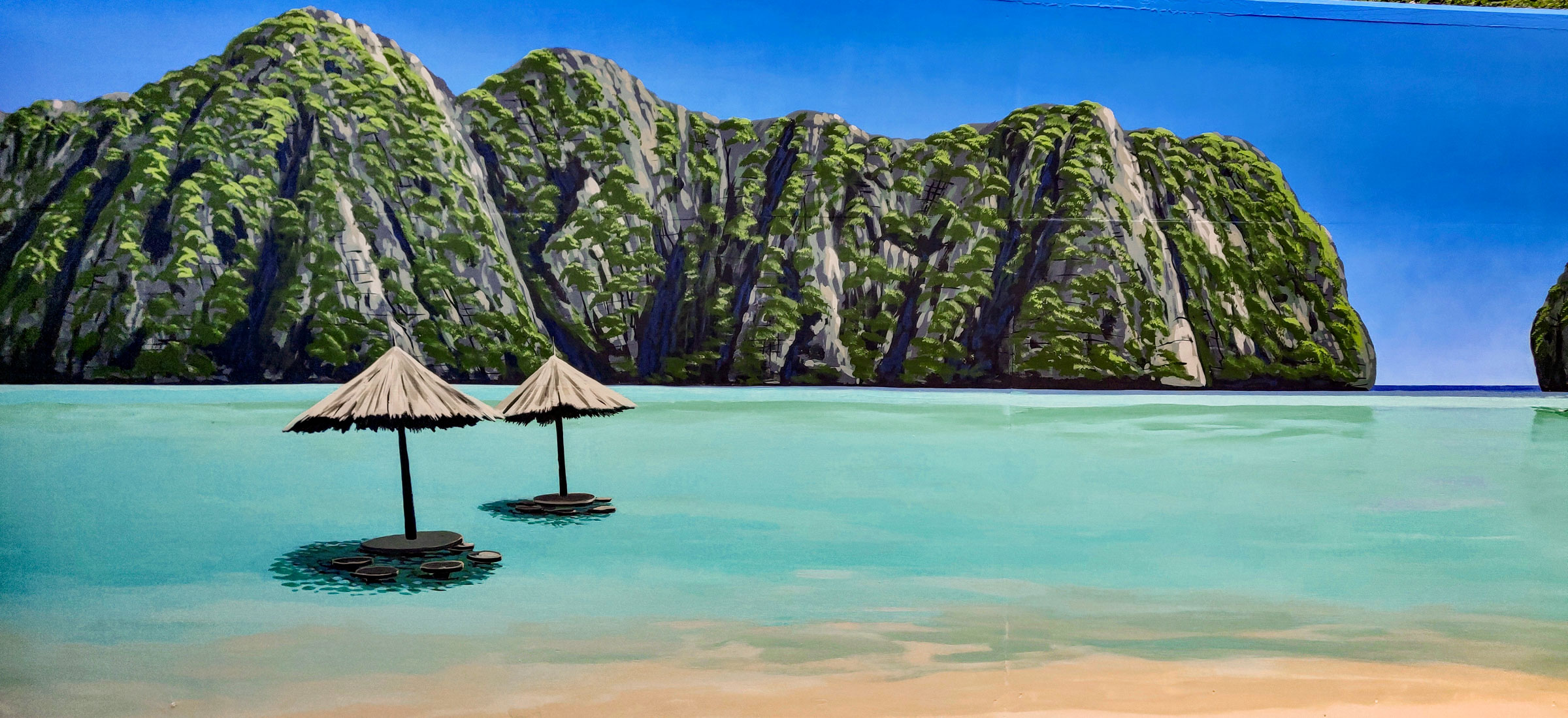 Thailand Holiday Memories Mural with a couple of parasol tables