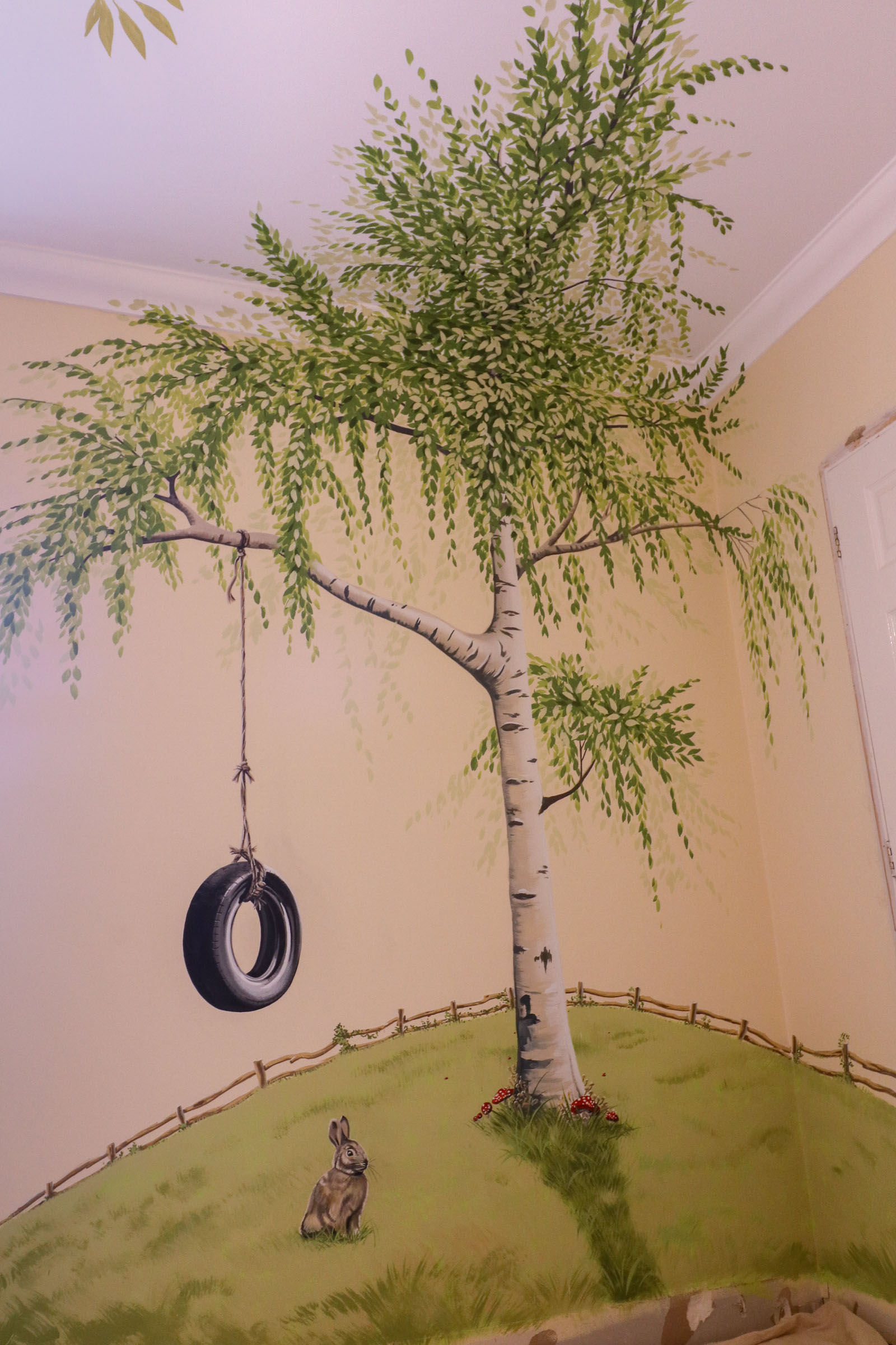 Bunny, tyre swing and silver birch on opposite wall