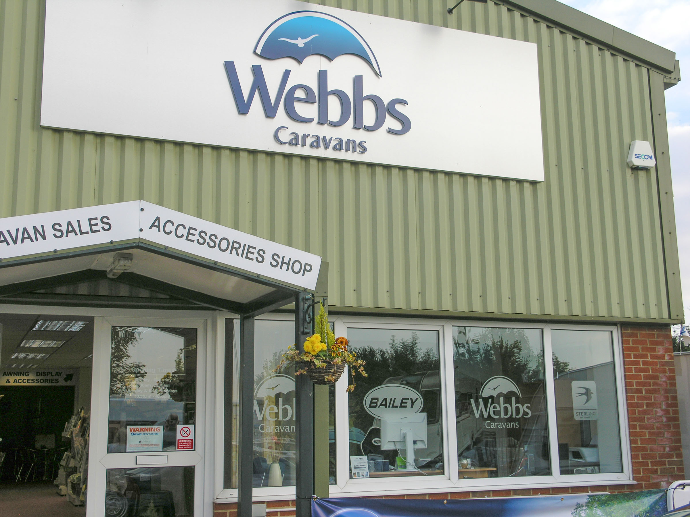 Webbs Caravans entrance, with the mural just visible throught he window