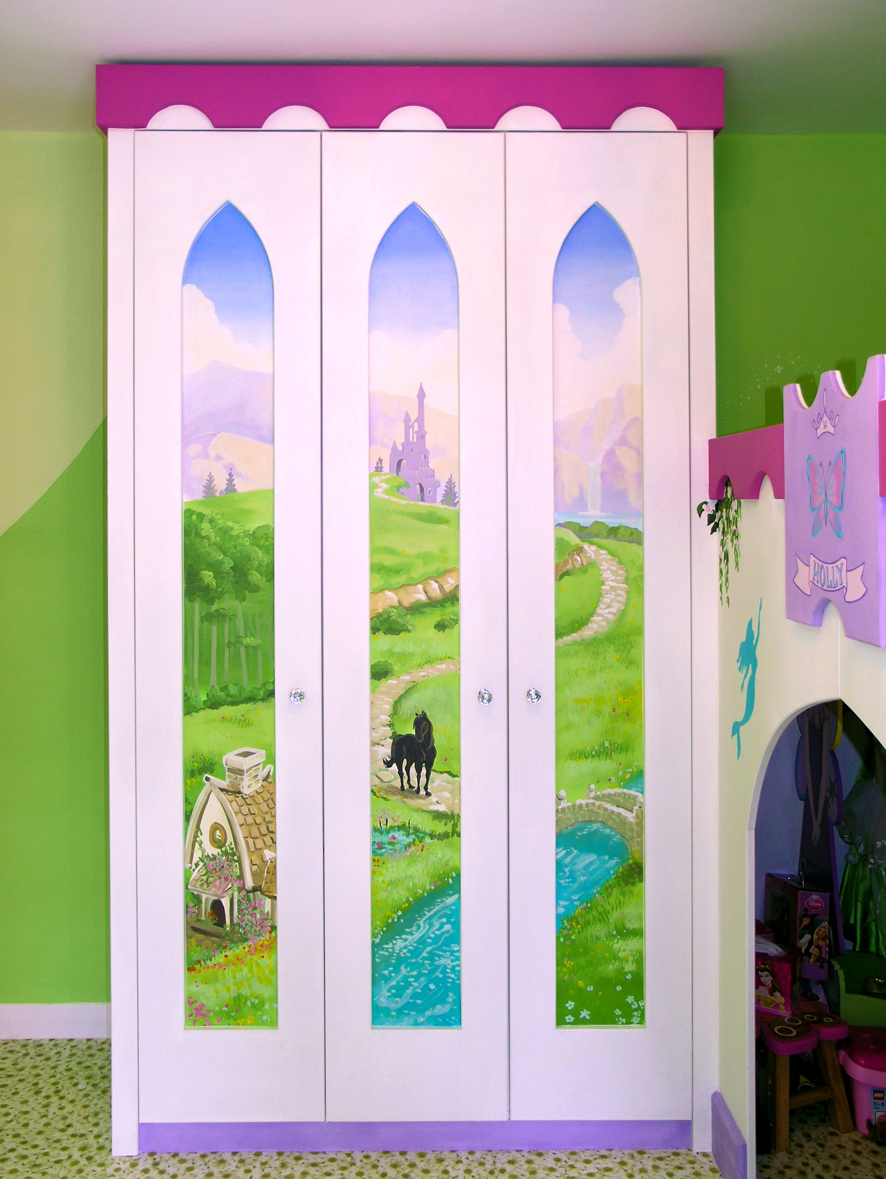 Painted wardrobe with fantasy kingdom seen through arched "windows"