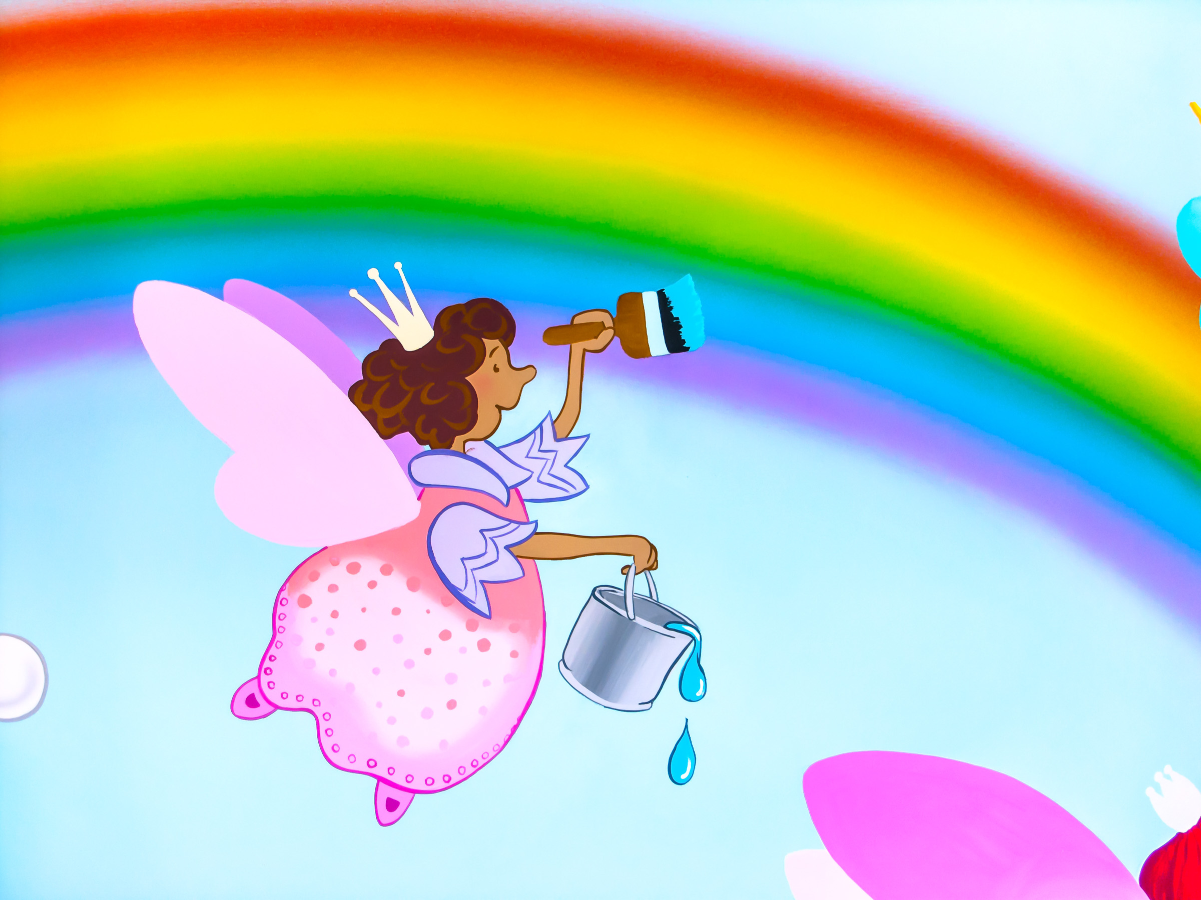 Pretty fairy painting a rainbow