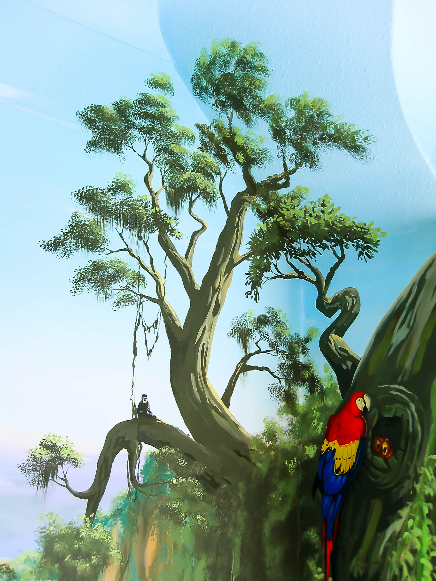 Parrot and a monkey in a couple of trees