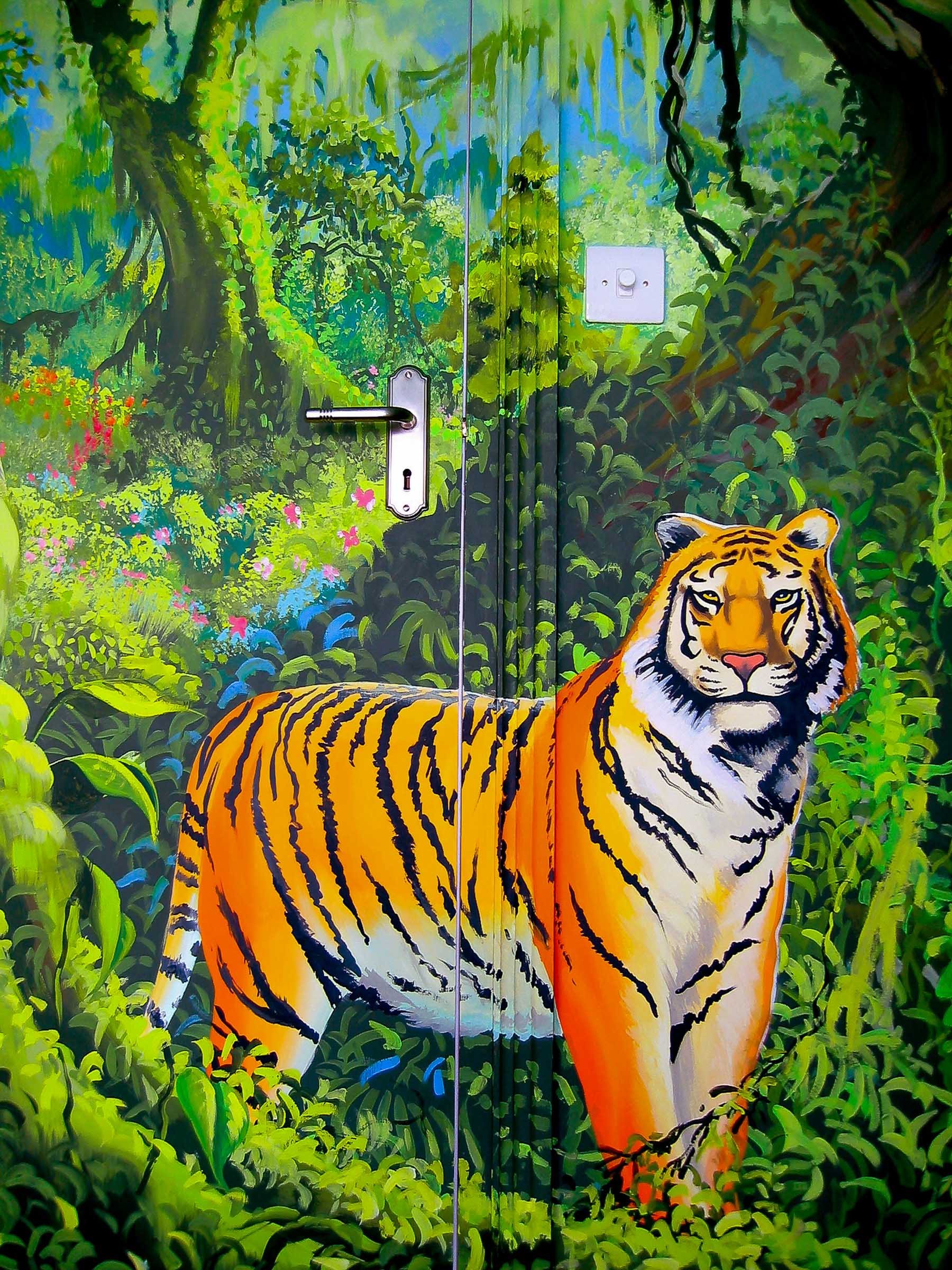 Majestic tiger part of the jungle mural, painted over the door and frame