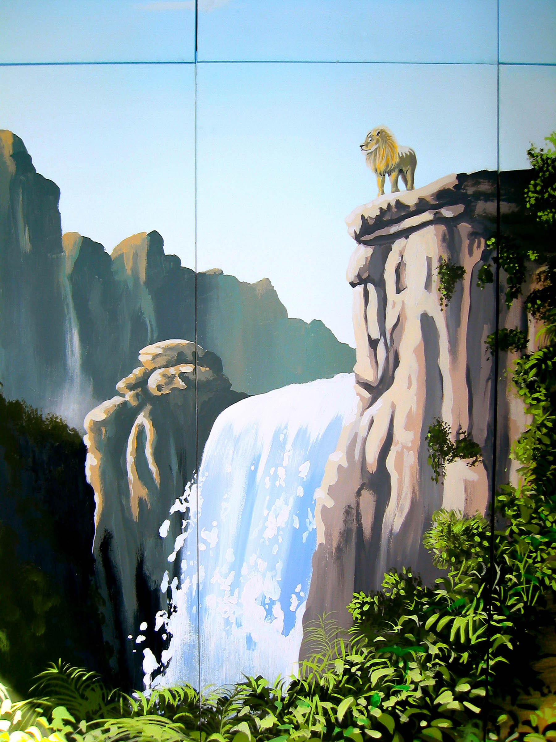 Waterfall and lion standing on the rocks painted on the doors of this fitted wardrobe.
